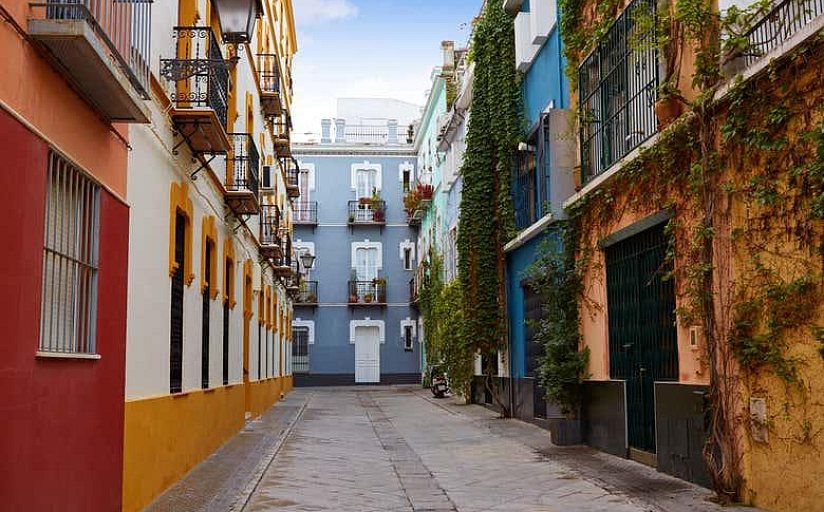 Calle con fachadas de colores y balcones en el barrio de la Macarena, Sevilla